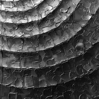 Black white photo with circular pattern, like a tire tread on wood