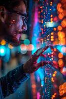 A man wearing glasses is using his finger to interact with a screen photo