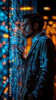 A man is focused on a computer screen displaying numerous dots photo