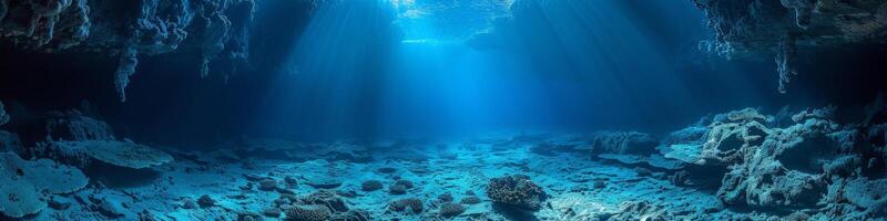 The sun shining through the ceiling of a underwater cave in the ocean photo