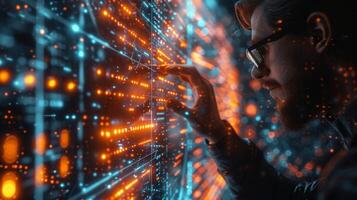 A man with glasses is gazing at a computer screen in a room photo
