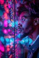A man in glasses looks at his reflection in a mirror photo