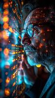 A man with glasses and a beard focused on computer screen photo