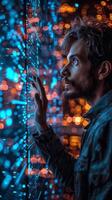 A man with a beard is watching a screen filled with bright lights at an event photo