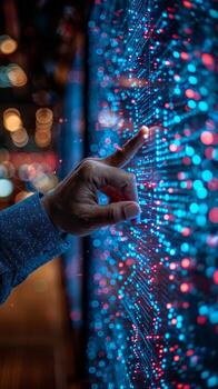 A person is touching a screen with their finger, interacting with it photo