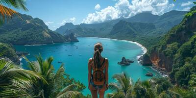 A woman stands on a cliff looking at water and mountains photo