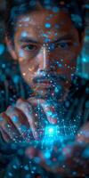 A man holds a glowing object in his hands in front of his face photo
