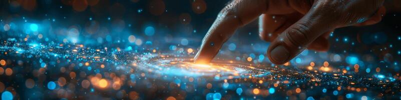 A persons finger is pointing towards a shimmering galaxy photo