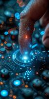 A persons finger is pushing a button on a blue circuit board photo