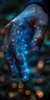 Close up of a hand with blue lights emitting from it photo