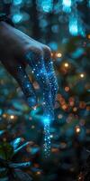 Close up of a hand with blue lights emitting from it photo