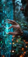 A persons hand is reaching out to touch a digital screen in the darkness photo