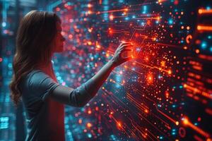 A woman is using her hand to interact with a futuristic screen photo