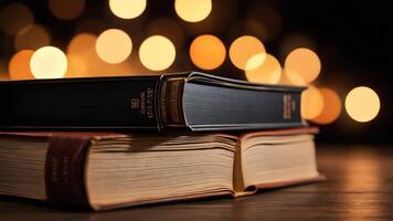a stack of books on a table with red lights photo