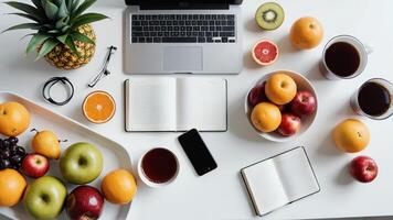 a laptop, fruit, and coffee on a table photo