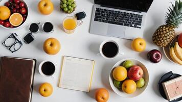 a laptop, fruit, and coffee on a table photo