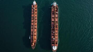 an aerial view of two cargo ships in the ocean photo