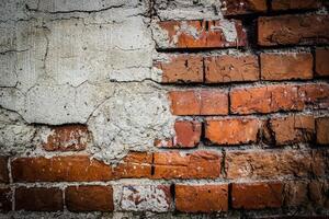 the texture of an old brickwork with fragments of plaster photo