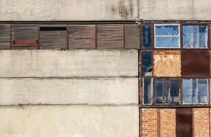 the wall with the windows of the old abandoned factory photo