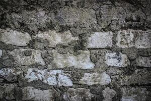 the texture of an old white brick masonry with remnants of plaster photo