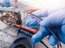 Fan motor winding repair process, concept of checking and repairing motor windings using a tester. photo