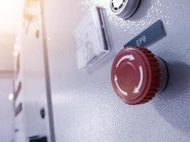 Close up the Emergency Push Button isolated on the control panel. photo
