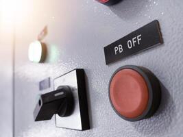 Close up the push button off and selector switch with indicator light on the panel control. photo