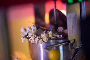 A close-up shot captures the mesmerizing process of making cinema popcorn, with kernels popping and releasing an irresistible aroma, promising a delightful snack for moviegoers photo