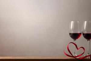 valentine's day, two glasses of champagne, red heart ribbon on a wooden table with space for text on a light background photo