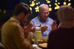 In a modern restaurant setting, a European Islamic family comes together for iftar during Ramadan, engaging in prayer before the meal, uniting tradition and contemporary practices in a celebration of photo