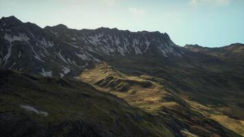 A view of a mountain range from the top of a hill video