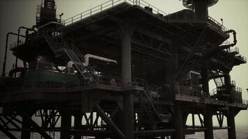 A massive oil rig in the middle of the ocean, with numerous pipes and structures video