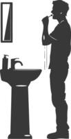 silhouette man brushing his teeth in front of the sink black color only vector