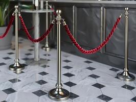 Stanchions with red velvet ropes, cut out in high resolution photo