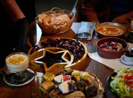 In this captivating aerial view, delicious food adorned with Ramadan decorations, including dates and meat, awaits the arrival of an European Islamic family, promising a festive and flavorful iftar photo