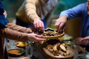 In this modern portrayal, a European Islamic family partakes in the tradition of breaking their Ramadan fast with dates, symbolizing unity, cultural heritage, and spiritual observance during the holy photo