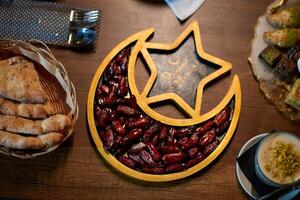 In this captivating aerial view, delicious food adorned with Ramadan decorations, including dates and meat, awaits the arrival of an European Islamic family, promising a festive and flavorful iftar photo
