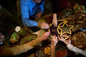 In this modern portrayal, a European Islamic family partakes in the tradition of breaking their Ramadan fast with dates, symbolizing unity, cultural heritage, and spiritual observance during the holy photo