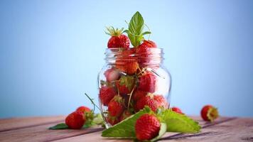 fresh sweet red strawberries in a glass jar video