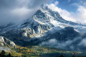 Mountains covered in snow and clouds with trees in the foreground photo
