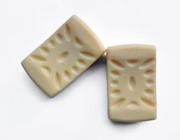 Yellow soap with blank label with color on gray background photo