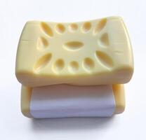 Yellow soap with blank label with color on gray background photo