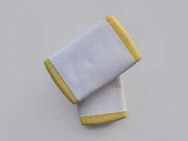 Yellow soap with blank label with color on gray background photo