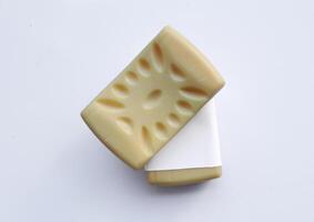 Yellow soap with blank label with color on gray background photo