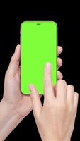 A woman's hand holds a phone chromakey Mockup and the second hand with a finger scrolls. Isolated on black background animation vertical 4k video