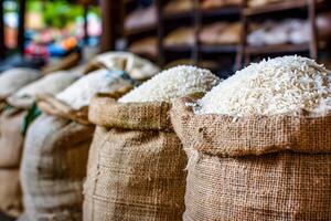 Multiple bags of rice arranged on market shelf photo
