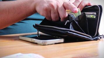 Male Hands Counting a Stack of 100 Dollar Bills on Blurred Money Background. Stack of banknotes in 10000 american dollars currency strap for hundreds. Investments in cryptocurrency. Capital. Wealth. video