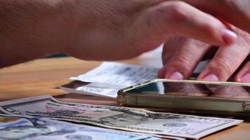 Male Hands Counting a Stack of 100 Dollar Bills on Blurred Money Background. Stack of banknotes in 10000 american dollars currency strap for hundreds. Investments in cryptocurrency. Capital. Wealth. video