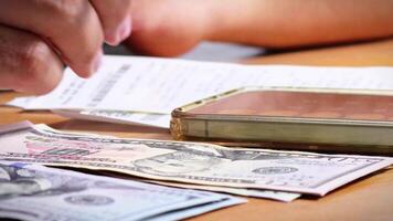 Male Hands Counting a Stack of 100 Dollar Bills on Blurred Money Background. Stack of banknotes in 10000 american dollars currency strap for hundreds. Investments in cryptocurrency. Capital. Wealth. video