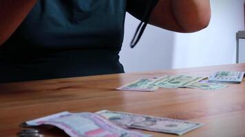 Male Hands Counting a Stack of 100 Dollar Bills on Blurred Money Background. Stack of banknotes in 10000 american dollars currency strap for hundreds. Investments in cryptocurrency. Capital. Wealth. video